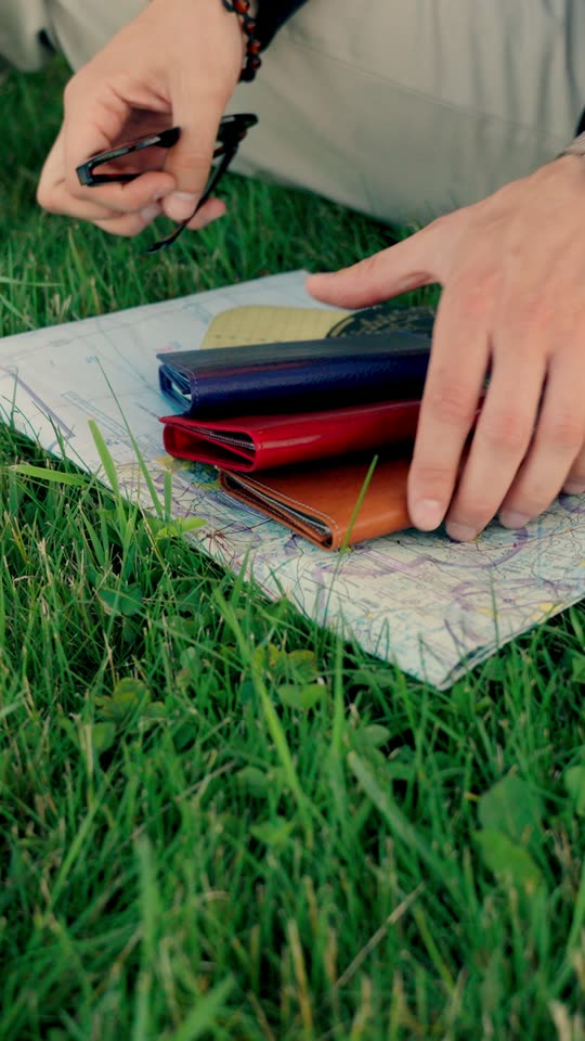 Pilot placing leather wallets on an aviation sectional chart outdoors — Pilot Wallets — Zephyr Aviation